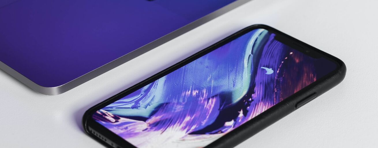 Smartphone mit lila Hintergrundbild